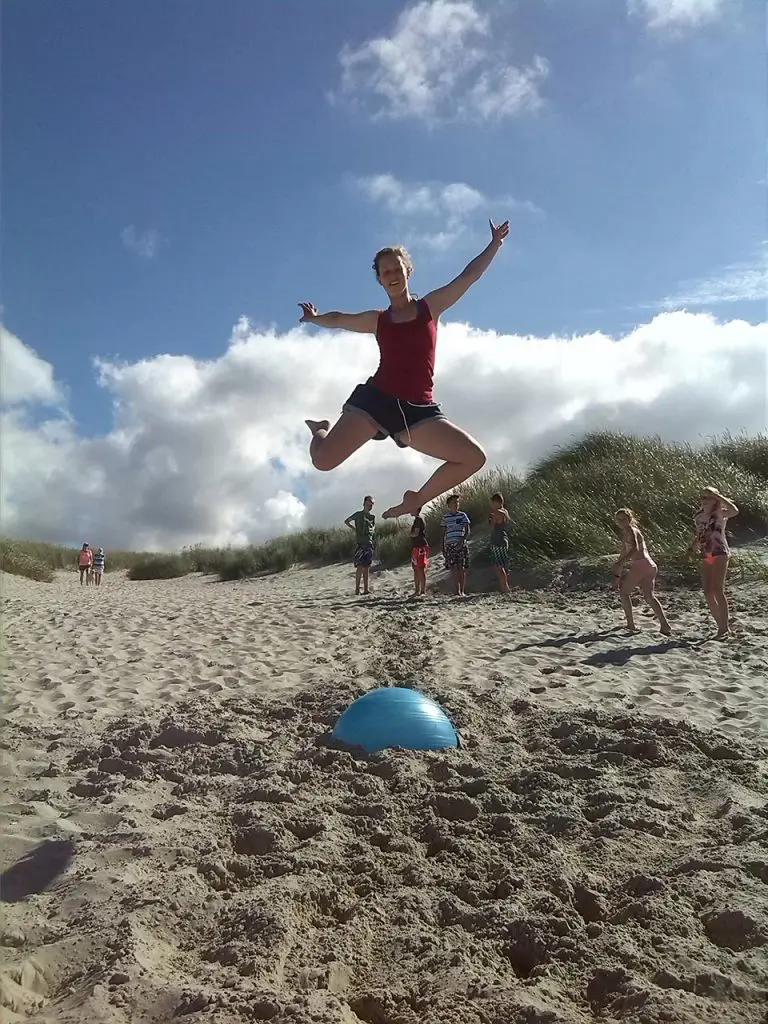 Junge NTB Sportlerin springt in die Luft am Strand